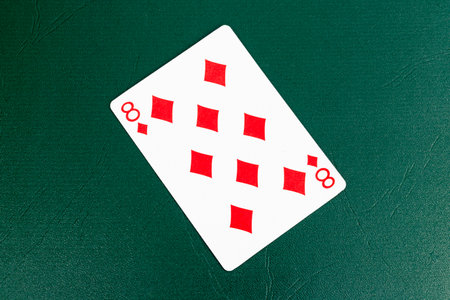 Eight of Diamonds Playing Card on Green Backgroundの写真素材