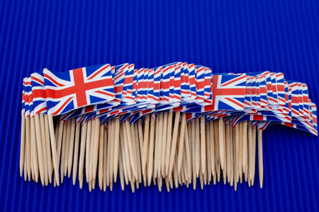 United Kingdom small paper flags on blue backgroundの写真素材