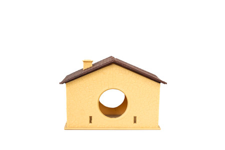 Miniature Yellow Toy House with Circular Opening Isolated on White Backgroundの写真素材