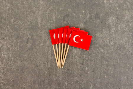 Miniature Turkish Flag Toothpicks Arranged in Fan Shape on Grey Backgroundの写真素材