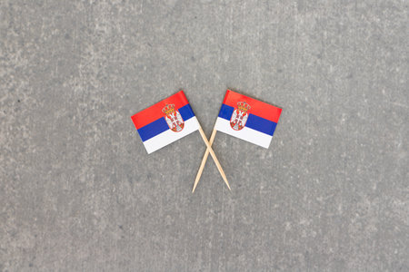 Two Serbian Flags on Crossed Toothpicks with Grey Stone Backgroundの写真素材