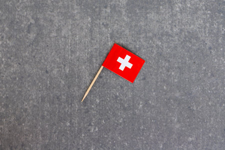 Angled Switzerland Mini Flag with Toothpick on Gray Backgroundの写真素材