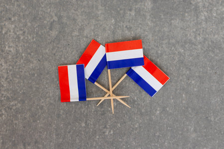 Dutch Flags Arranged in Circle Pattern on Gray backgroundの写真素材