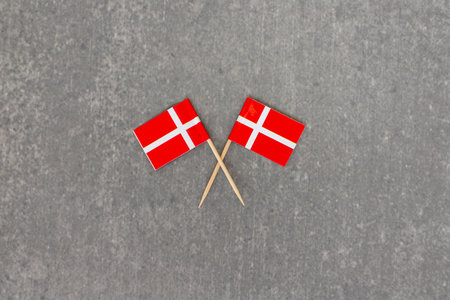 Crossed Denmark Flags on Gray Backgroundの写真素材