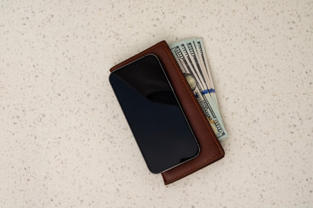 Smartphone, Wallet and Dollar Bills Stacked. Top View.の写真素材