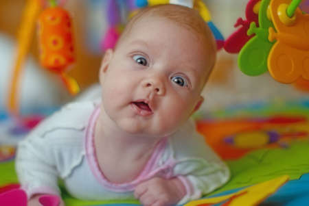 Beautiful baby with toysの写真素材