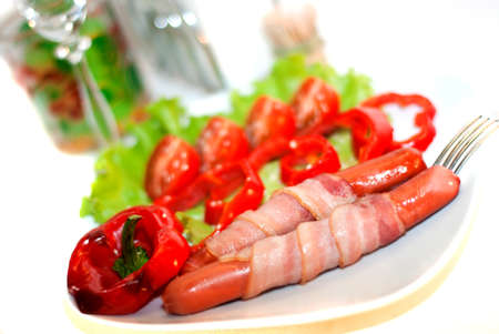 Grilled sausages with becon and vegetablesの写真素材