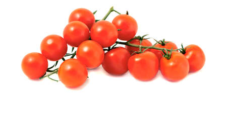 The branch of tomatos-cherry on a white backgroundの写真素材