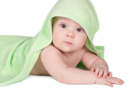 Cute baby with green towel  on a white backgroundの写真素材