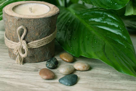 Wood candle with stones and leafs.の写真素材