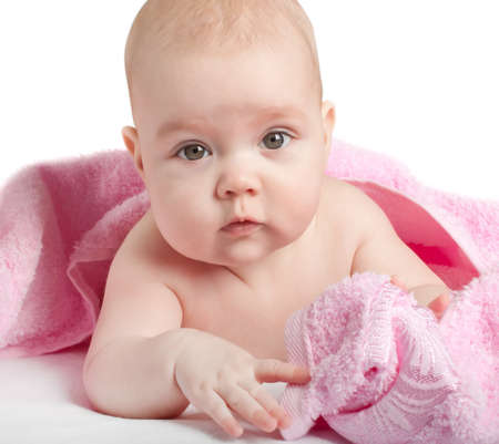 Cute baby with a pink towel on a whiteの写真素材