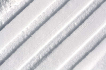 Tyre tracks in winter, to use as a backgroundの写真素材