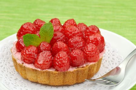 Fruit tartlet on a plate and green backgroundの写真素材