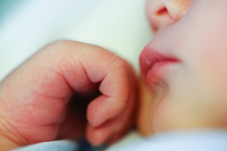 Newborn Baby hand and faceの写真素材