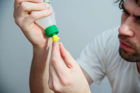 Man glue the broken plastic with glueの写真素材