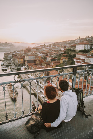 Young couple are on holiday over the Douro river in Porto, Portugalの写真素材