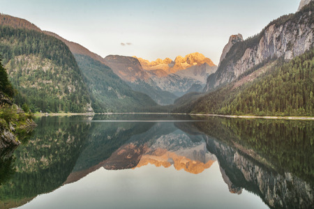 Mountain Lake with a beautiful reflection at sunsetの写真素材