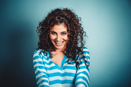 Happiness. Closeup portrait head shot happy beautiful young woman laughing looking at you camera isolated blue background wall. Positive human emotion face expression feeling life perception  attitudeの写真素材