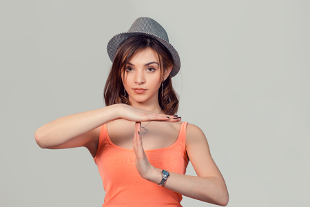 Closeup portrait young calm seriuos woman showing time out gesture with hands isolated on light gray wall background. Positive human emotion facial expressions feeling body language reaction attitudeの写真素材
