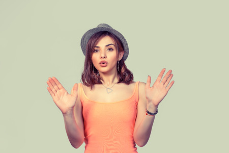 Stop right here. Closeup portrait of angry annoyed young woman raising hand up to say no stop right there isolated on light green background. Negative human emotion facial expressionの写真素材