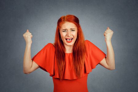 portrait angry woman screaming wide open mouth hysterical isolated gray background. Negative human face expression emotion bad feeling reaction. Conflict confrontation concept. Too many things to doの写真素材