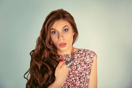 Portrait closeup of young woman looking at you camera with shocked surprised face expression...