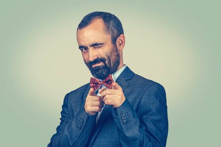 Closeup portrait of man pointing at you with fingers at you camera with hands shaped like guns while...