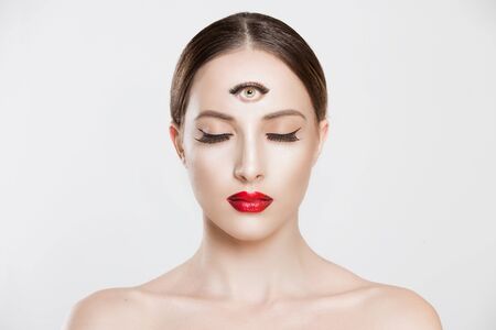 Psychic. Woman with 3 third eye looking at you camera concentrating thinking with mind and heart intuition about problem isolated white grey background. Making smart decision find solution conceptの写真素材
