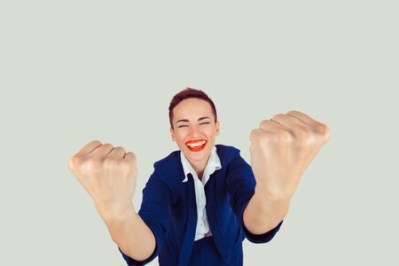 Yess, we can do it. Happy excited woman exults pumping huge fists ecstatic celebrates success isolated light green background wallの写真素材