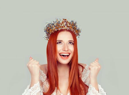 Happy beauty queen woman exults pumping fists ecstatic celebrates success pretty woman with crystal crown on head isolated on light green gray background wallの写真素材
