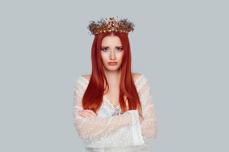Portrait upset beauty queen, woman looking suspicious, disapproval on face arms crossed folded unhappy pretty woman with crystal crown on head isolated on light gray background wallの写真素材