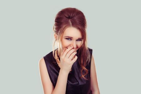 Laughing shy. Beautiful woman smiling hand on face isolated light green wall background. Happiness...
