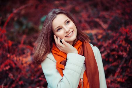 Woman talking on her mobile phone outdoorsの写真素材