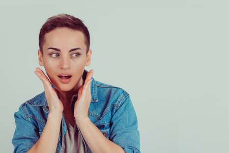 Wow. Close up portrait young woman beautiful girl with short hair looking to the side excited...