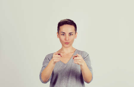 It's you! Portrait angry annoyed pin up retro style woman getting mad pointing finger at you camera showing hand gesture this is you, you chosen isolated on yellow wall background. Negative emotionsの写真素材