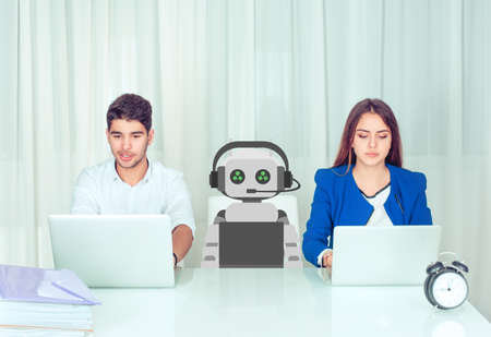 Concept of coworking young man and woman with innovative robot sitting at table in office. Customer...