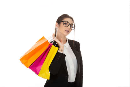 Closeup cutout portrait of a beautiful woman holding multicolored shopping bags posing, girl wearing...