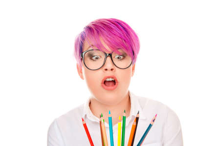 Puzzled designer. Doubtful business woman thinking looking on colored pencils. Lady with pink hair thoughtful girl with pens in buttoned formal shirt isolated on white background wall. Face expressionの写真素材