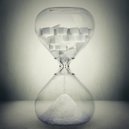 Sugar kills in time, death concept. Closeup of hourglass with sugar in cubes that is pouring down...