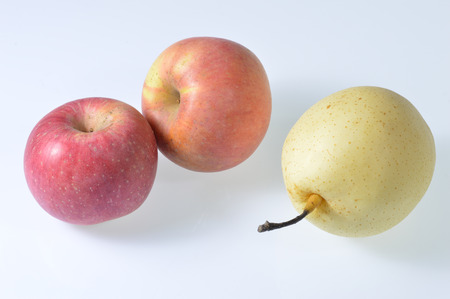 Under the background of white pear and appleの写真素材