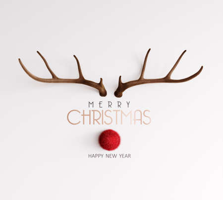 Christmas greeting card with deer antlers on white background. Merry Christmas and Happy New Year!の写真素材