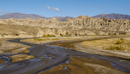 River flowing down from the mountains and eroded mountains forming broad valleys