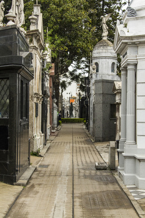 internal streets of Recoleta Cemetery in Buenos Aires. On the sides of the path we see the vaults where are the dead.のeditorial素材