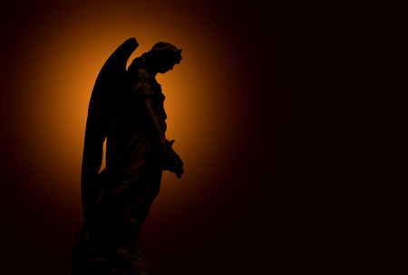 angel statue in the cemetery guarding the graves of the dead.の写真素材