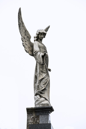 angel statue in the cemetery guarding the graves of the dead.の写真素材