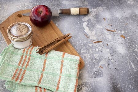 Red apple, Cinnamon, Sugar, wood table over rustic surfaceの写真素材