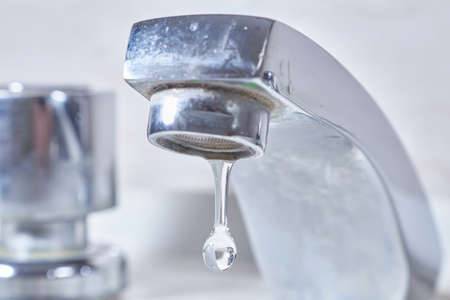 drops and faucet isolated on a white backgroundの写真素材