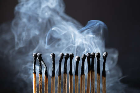 Burned, extinguished matches isolated on black background, clipping pathの写真素材