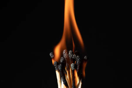group of match is ignite on a blurry wood background. Selective focus.の写真素材