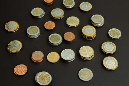 Different argentine coins stacked. Pile of money. Metal coins texture. Different denominations.の写真素材